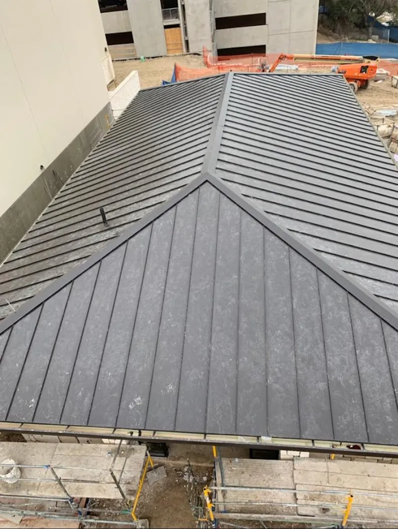 Commercial metal roof construction with crane equipment in Dayton
